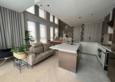 modern living space with open kitchen and dining area