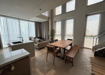 Spacious open-concept living and dining area with large windows