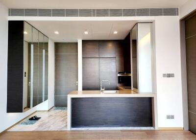 Modern kitchen with dark wood cabinetry and reflective surfaces