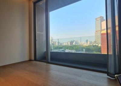 Spacious living area with a large window offering a city view