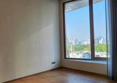 Modern bedroom with large window and city view