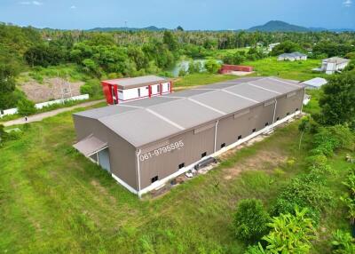 Exterior view of an industrial building with surrounding greenery