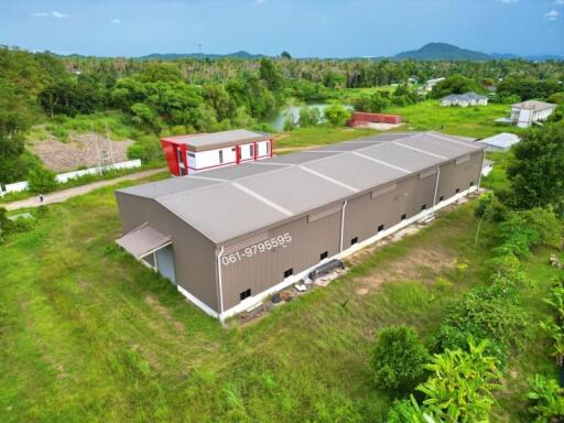 Exterior view of an industrial building with surrounding greenery