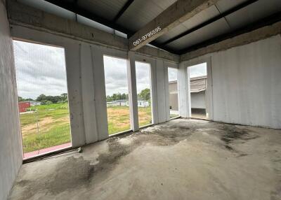 Unfinished room with large windows