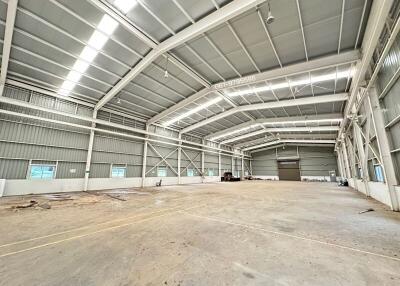 Spacious industrial warehouse with high ceilings and ample natural light.