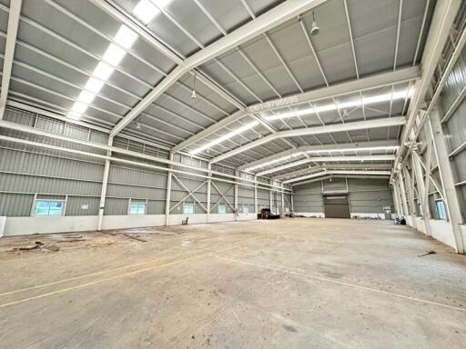 Spacious industrial warehouse with high ceilings and ample natural light.