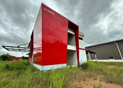 Exterior view of a modern red building in an open area