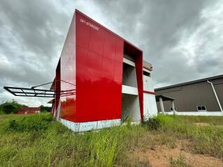 Exterior view of a modern red building in an open area