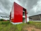 Exterior view of a modern red building in an open area