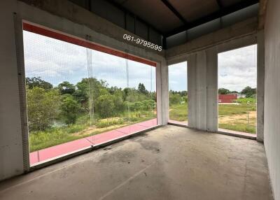 Unfinished room with large windows offering scenic outdoor view