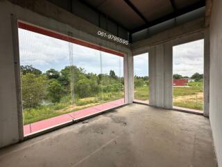 Unfinished room with large windows offering scenic outdoor view