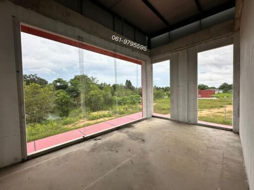 Unfinished room with large windows offering scenic outdoor view