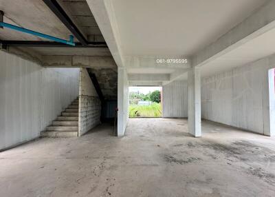 Empty interior of a building with concrete floors and stairs