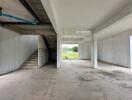 Empty interior of a building with concrete floors and stairs