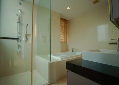 Modern bathroom with bathtub and glass shower enclosure