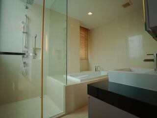 Modern bathroom with bathtub and glass shower enclosure