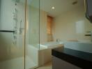 Modern bathroom with bathtub and glass shower enclosure