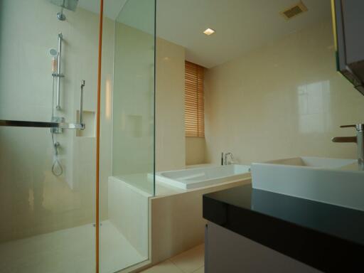 Modern bathroom with bathtub and glass shower enclosure