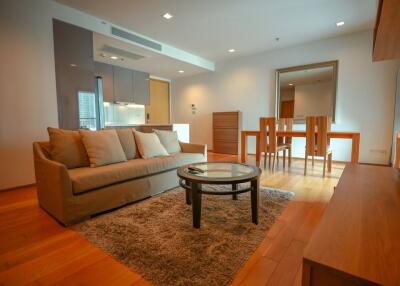 well-lit main living area with couch and dining table