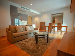 well-lit main living area with couch and dining table