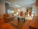 well-lit main living area with couch and dining table