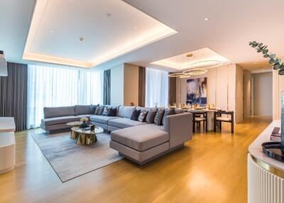 Spacious and modern living area with large sectional sofa and dining table