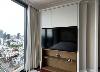 Modern bedroom with large window and wall-mounted TV