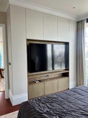 Modern bedroom with built-in entertainment unit