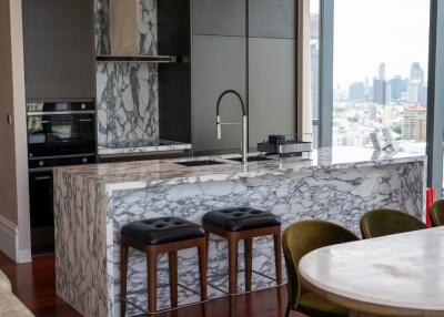 Modern kitchen with marble countertops and city view