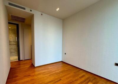 Empty bedroom with wooden flooring and small closet area