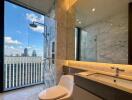 Modern bathroom with large glass shower, vanity, and city view