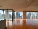 spacious living room with city view and wooden floor