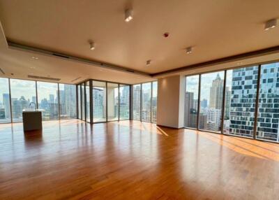 Spacious living room with floor-to-ceiling windows and city views