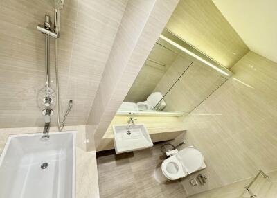 Modern bathroom with bathtub, sink, and toilet