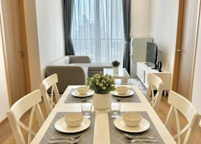 Modern dining room set up with a view of the living area