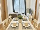 Modern dining room set up with a view of the living area