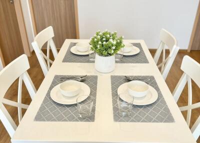 Bright and modern dining area with set table