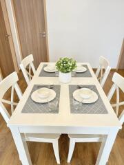 Bright and modern dining area with set table