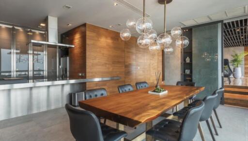 modern dining area with wooden table and stylish chandelier