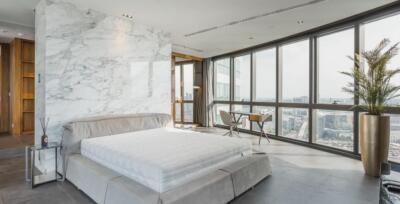 Modern bedroom with a large bed and city view