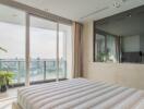 Spacious bedroom with a large bed and floor-to-ceiling windows leading to a balcony with a city view