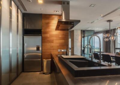 Modern kitchen with stainless steel appliances and dining area