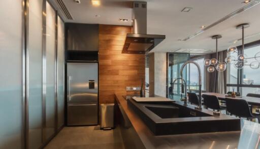 Modern kitchen with stainless steel appliances and dining area