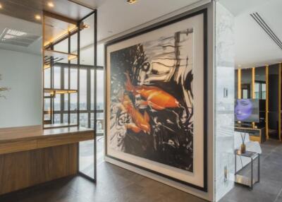 Modern living area with a large fish artwork, wooden and metal accents