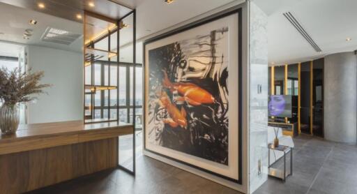 Modern living area with a large fish artwork, wooden and metal accents