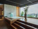 Main living space with large windows, jacuzzi, and city view