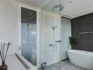 Modern bathroom with glass-enclosed shower, bathtub, and contemporary decor