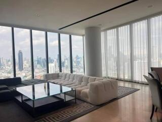 Spacious living room with large windows and city view