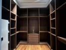 Spacious wooden walk-in closet with ample shelving and storage space