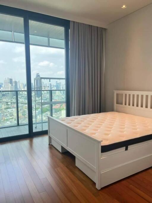 Modern bedroom with large window and city view